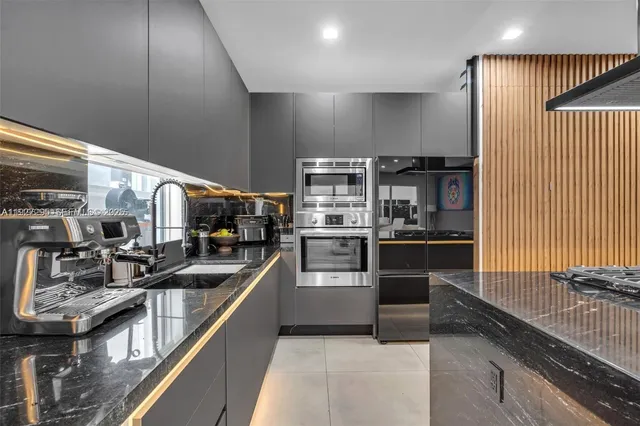 a kitchen with stainless steel appliances granite countertop a stove and a sink