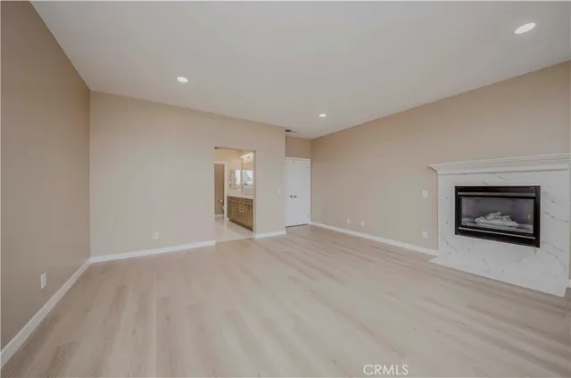 a spacious bathroom with a shower a sink and a mirror