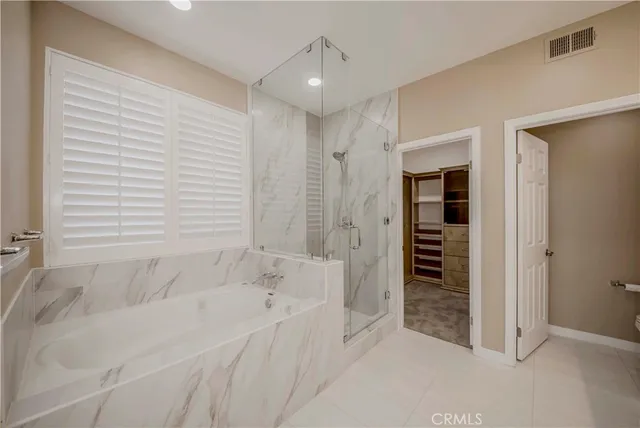 a bathroom with a bathtub and a shower