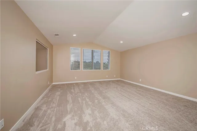 a spacious bedroom with a large bed and a large window