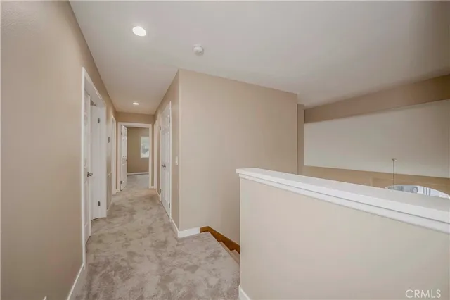 a spacious bedroom with a bed a couch and a flat screen tv