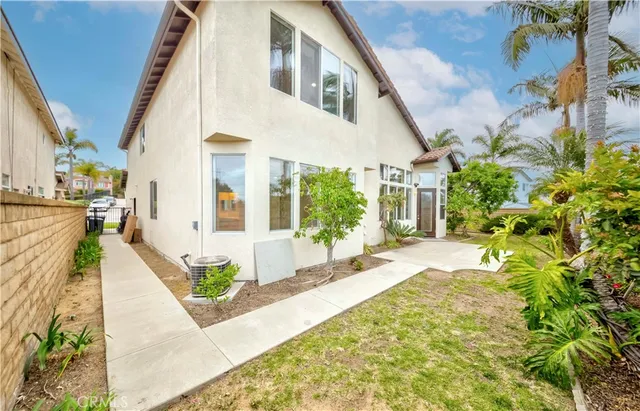 a front view of a house with a garden and plants