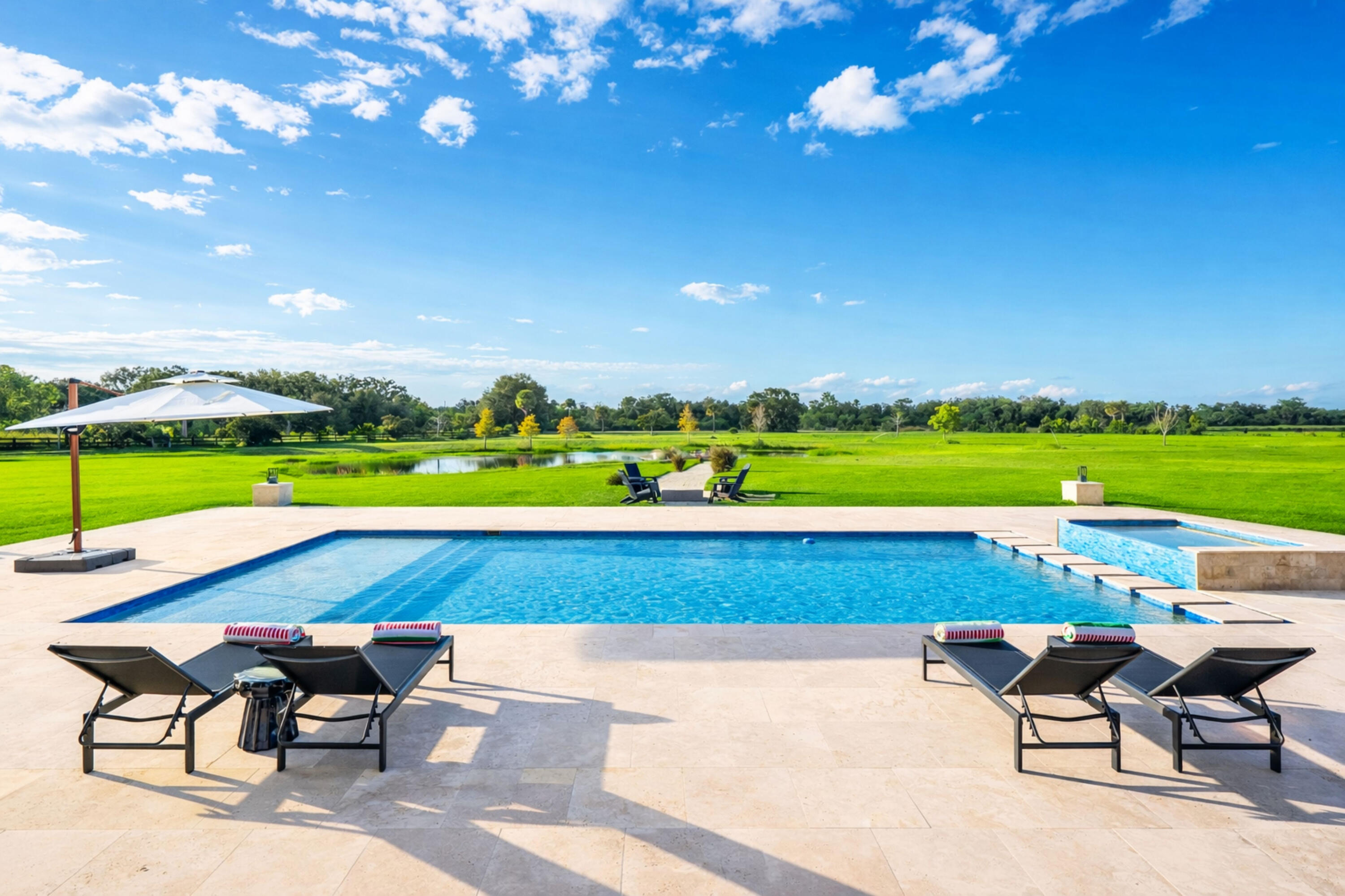 26209 Southwest Jockeys Run Okeechobee, FL 34974 - Photo 46 of 57 Sunny poolside retreat with lush landsca