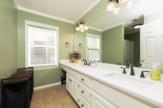 a bathroom with a sink double vanity and a mirror