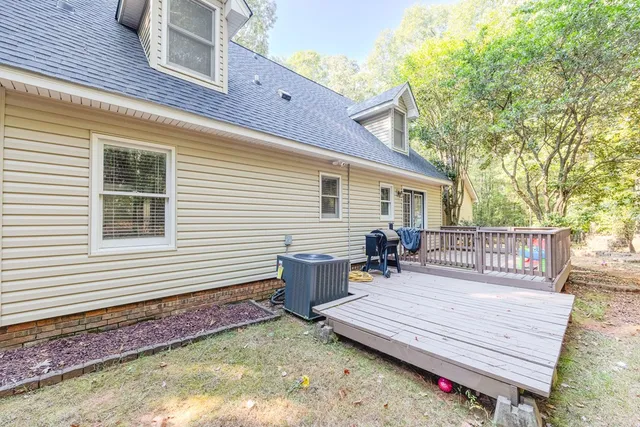 a view of a wooden deck with chairs and a yard