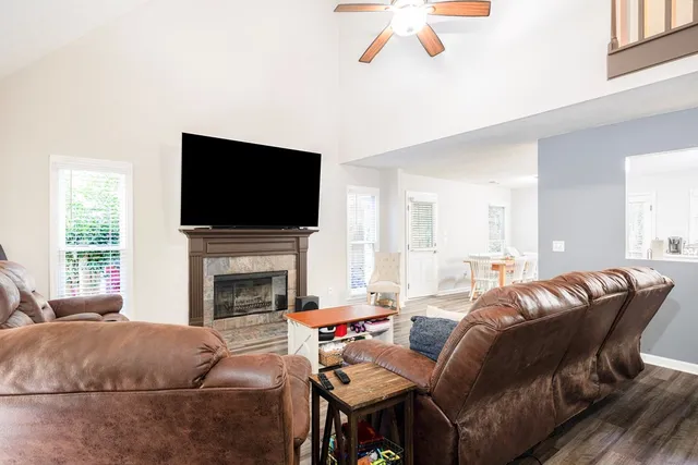 a living room with furniture a fireplace and a flat screen tv