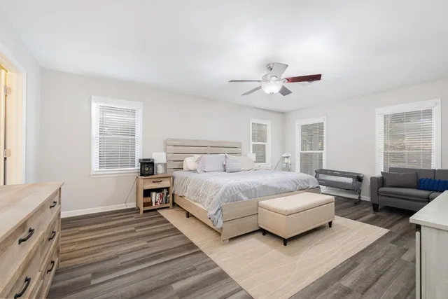 a bedroom with a bed couch and a window