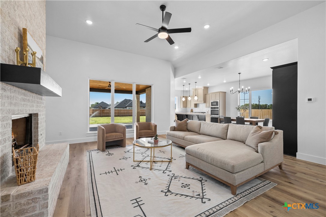 7949 Rock Crest Drive Moody, TX 76557 - Photo 1 of 47 a living room with furniture a fireplace and a flat screen tv