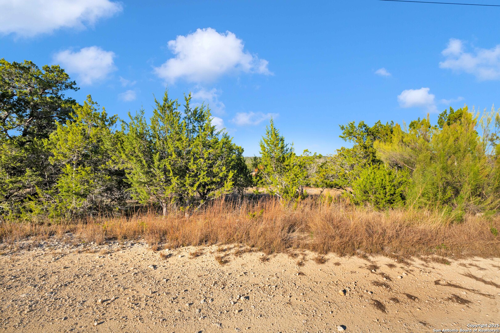 0 Walden Pond Bandera, TX 78003 - Photo 3 of 7 a view of a lake with a house in the background