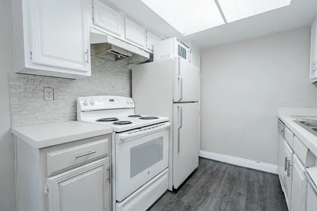 a kitchen with stainless steel appliances white cabinets and a stove