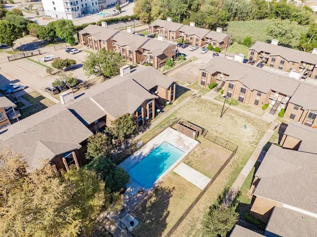 an aerial view of residential houses with outdoor space