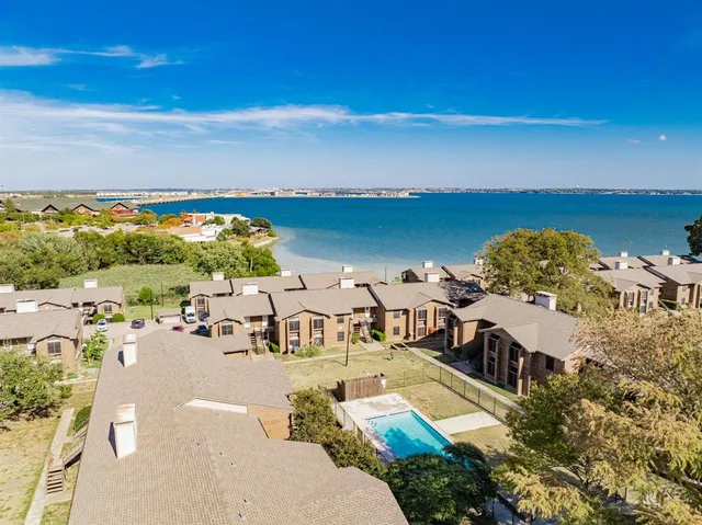 a view of a terrace with lawn chairs