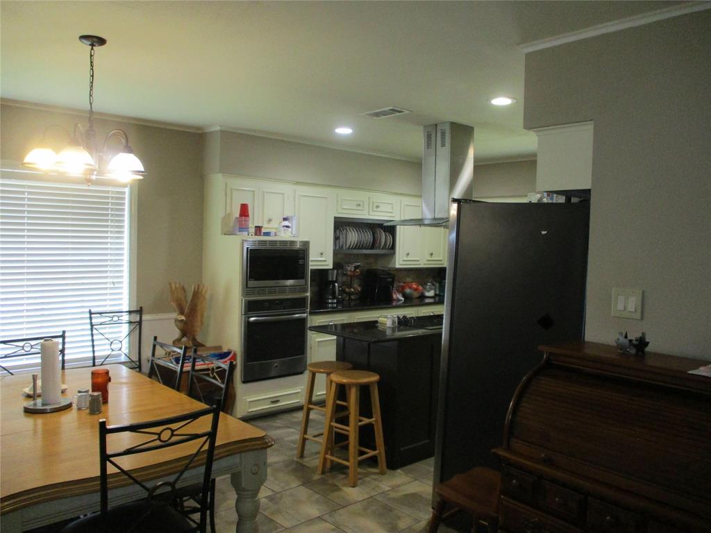 235 Industrial Point Point, TX 75472 - Photo 14 of 34 a kitchen with refrigerator and chairs