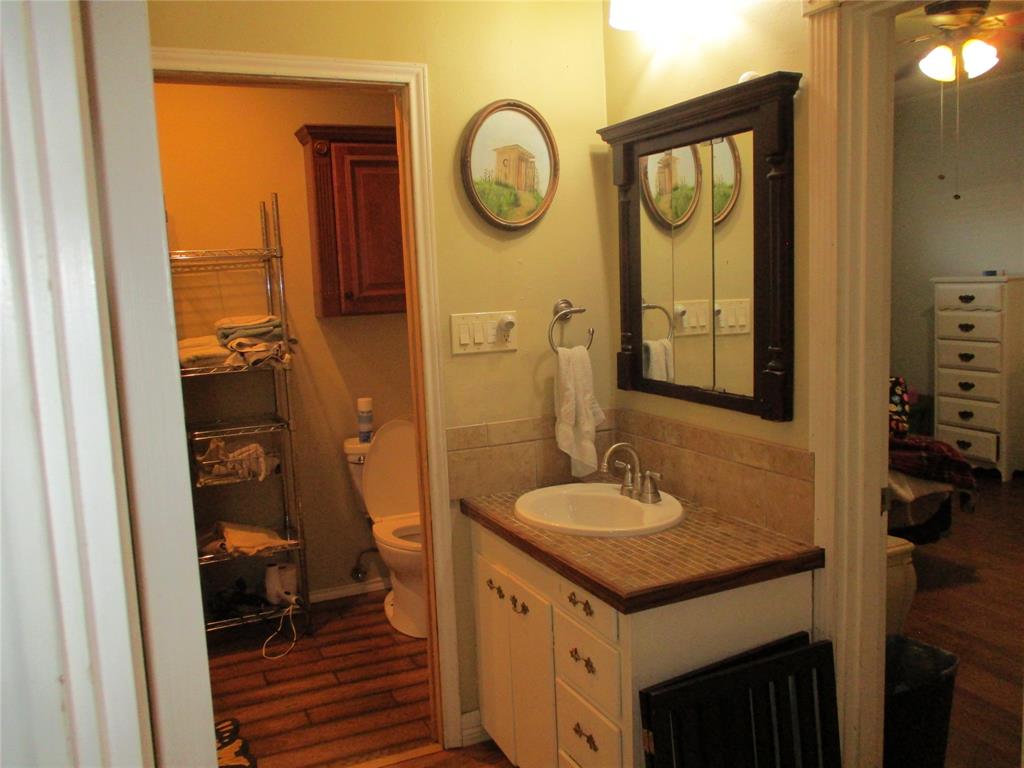 235 Industrial Point Point, TX 75472 - Photo 24 of 34 a bathroom with a granite countertop sink and a mirror