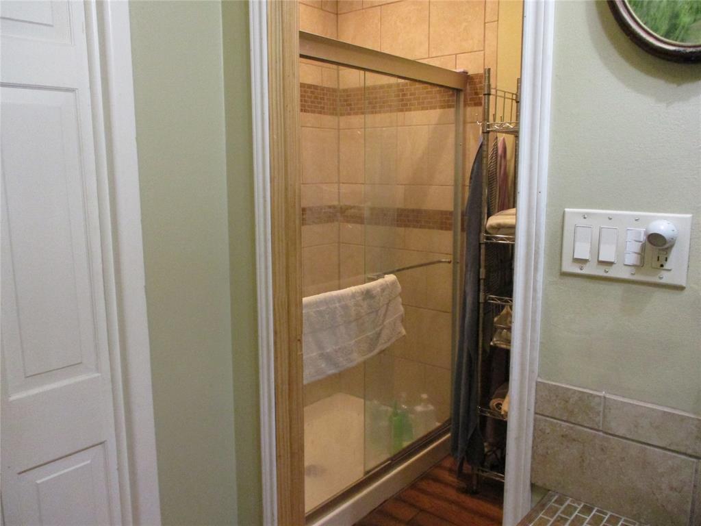 235 Industrial Point Point, TX 75472 - Photo 26 of 34 a bathroom with a glass shower door