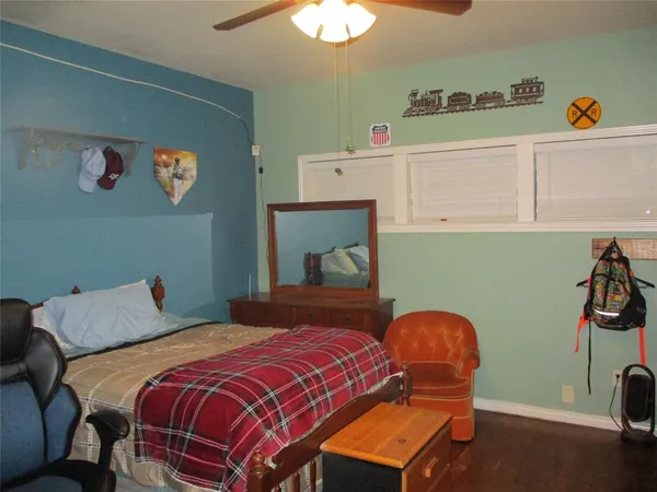a bedroom with a bed and a desk