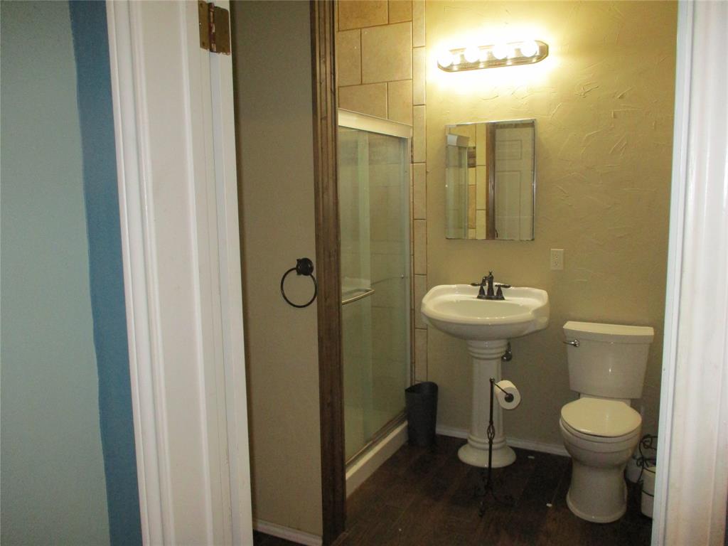 235 Industrial Point Point, TX 75472 - Photo 28 of 34 a bathroom with a toilet sink and mirror