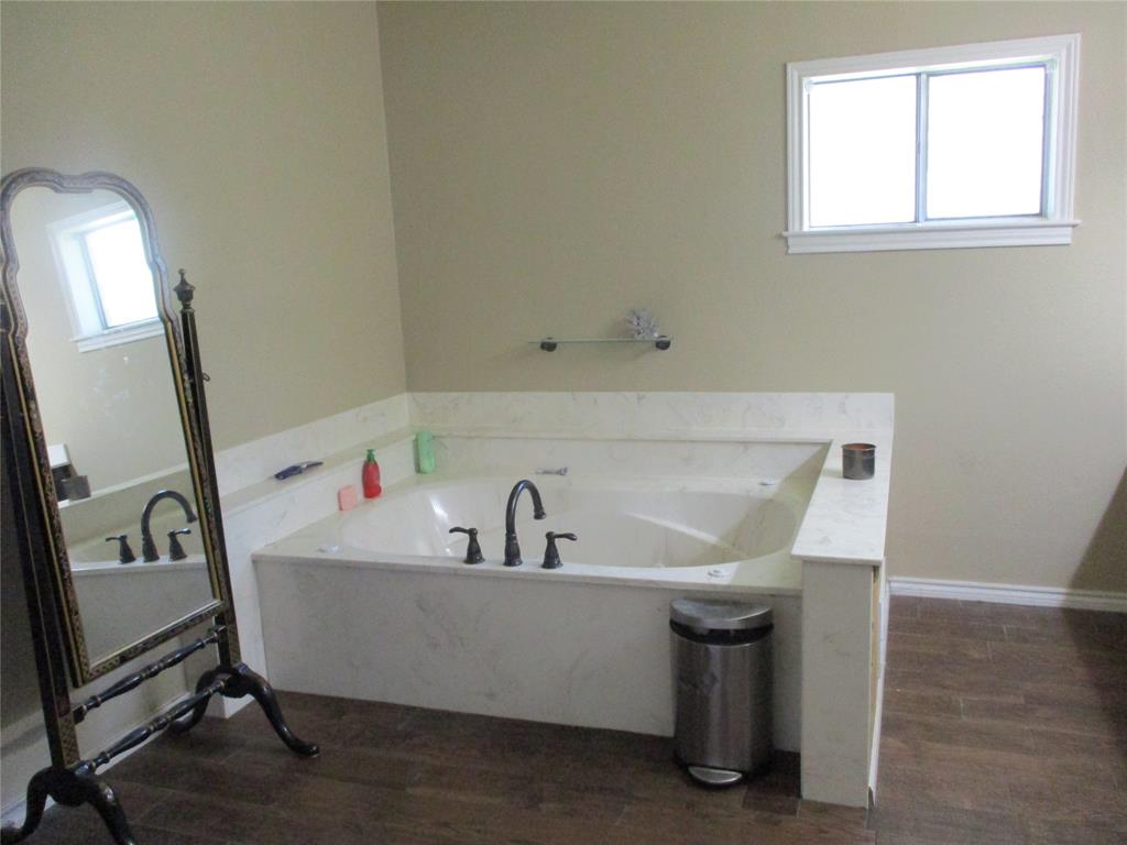 235 Industrial Point Point, TX 75472 - Photo 34 of 34 a bathroom with a sink a mirror and a bathtub