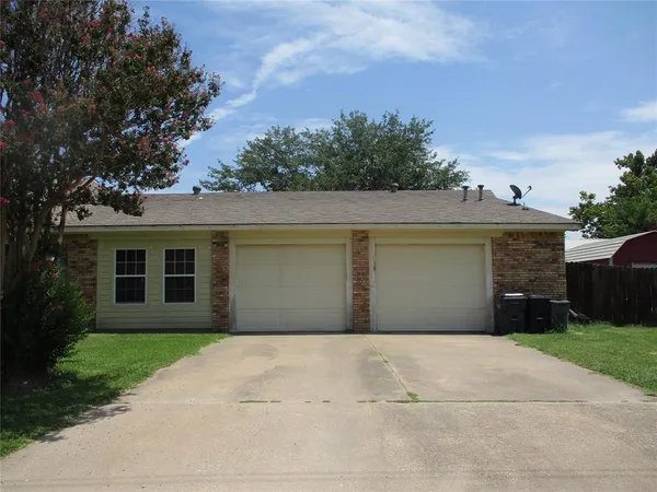 a front view of house with a garden