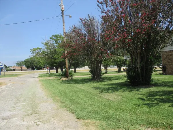 a view of a house with a yard and sitting area