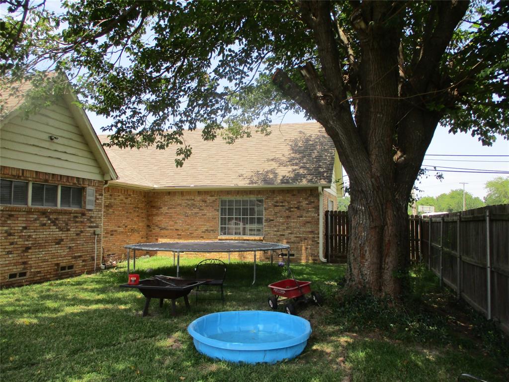 235 Industrial Point Point, TX 75472 - Photo 9 of 34 a view of a backyard with plants and a tree