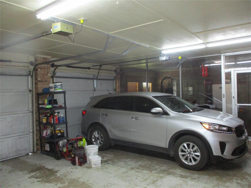 235 Industrial Point Point, TX 75472 - Photo 10 of 34 a car and bike parked in a garage