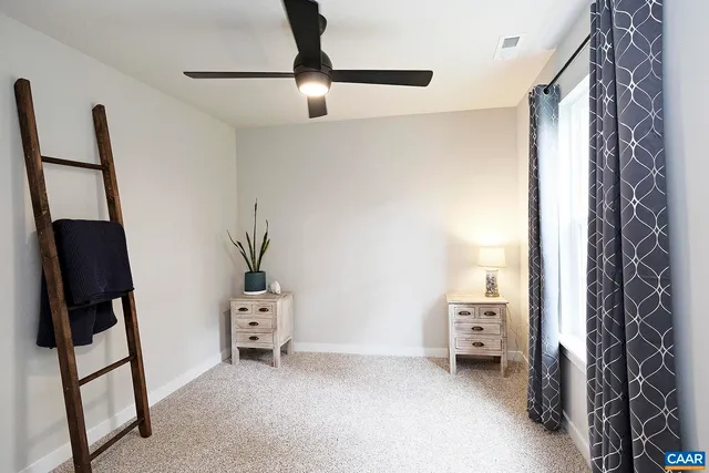 a view of bedroom with furniture and a window