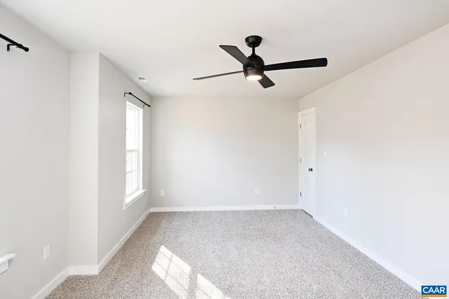 a view of a room with a ceiling fan