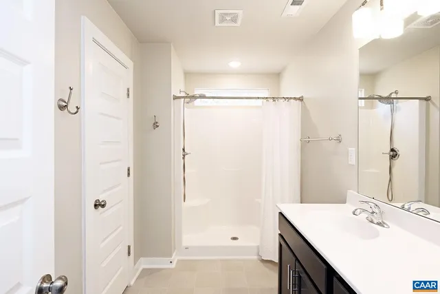 a bathroom with a sink a shower and a mirror