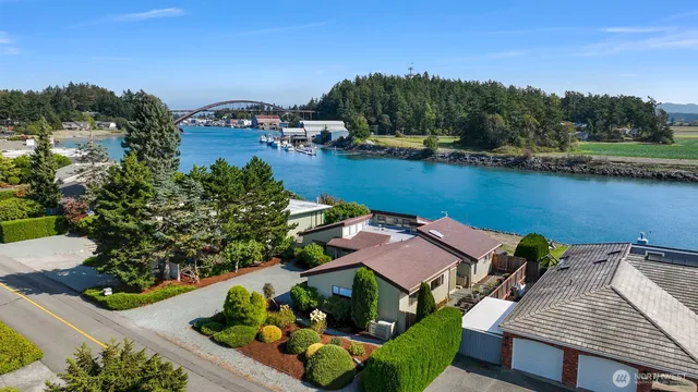 an aerial view of a house with a garden and lake view