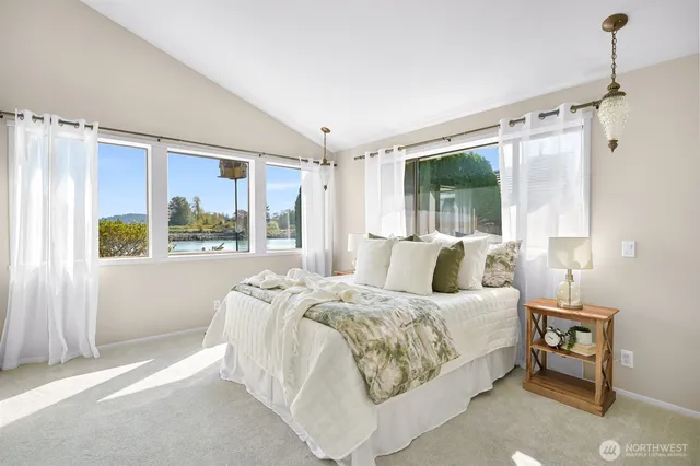 a bedroom with a large bed and a window