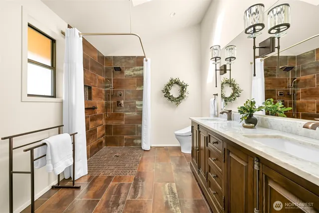a spacious bathroom with a double vanity sink a large mirror and a shower