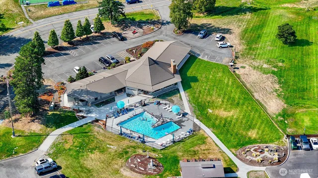 an aerial view of a house with a garden and swimming pool