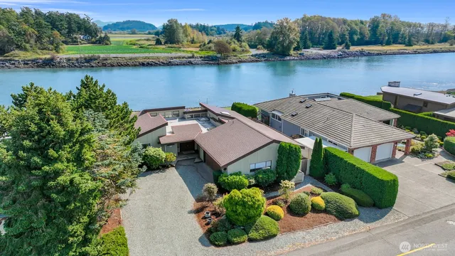 an aerial view of a house with garden space and lake view