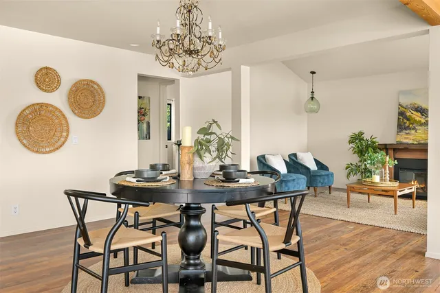 a view of a dining room with furniture and chandelier
