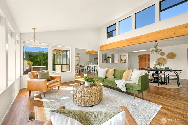 a living room with furniture and floor to ceiling windows