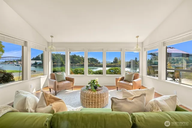 a living room with furniture and large windows
