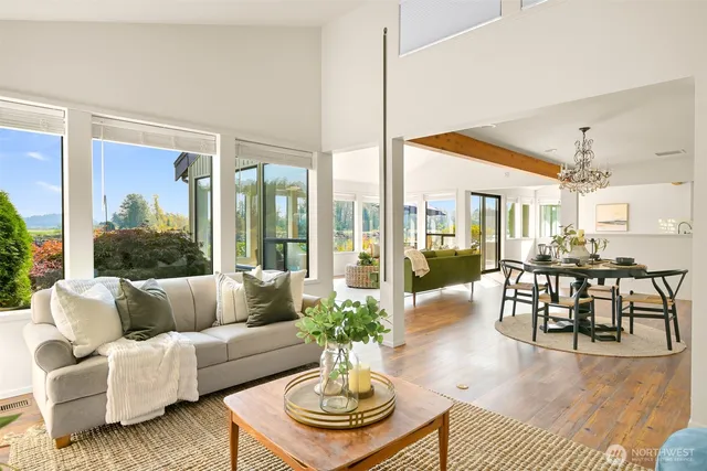 a living room with furniture dining table and a large window