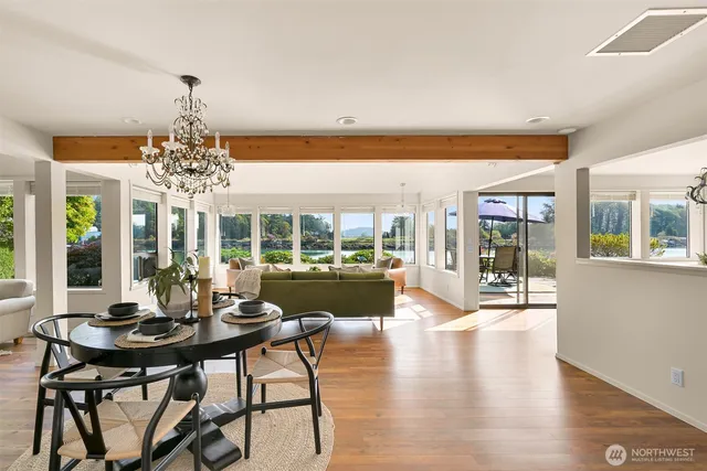 a view of a dining room with furniture wooden floor and chandelier