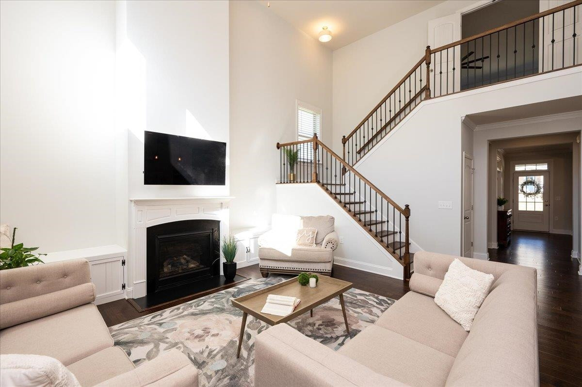 Open, wrought iron railing, and hardwood steps take you to the spacious 2nd floor. Stairway