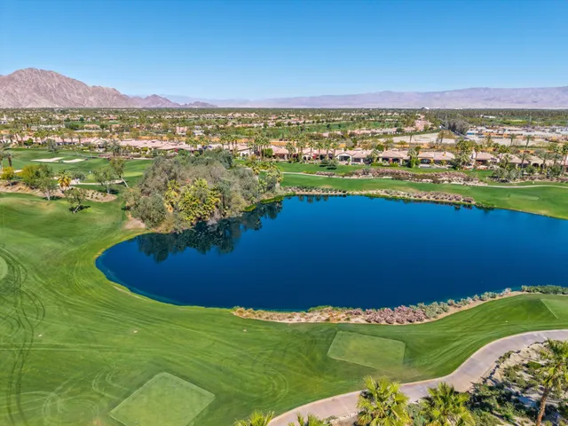 a living room with lots of furniture and a large window