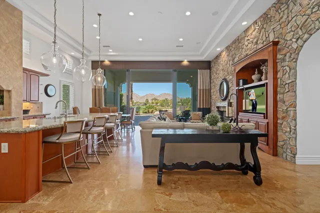 a living room with furniture a clock and a large window
