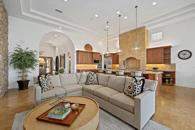 a kitchen with granite countertop a table chairs stove and cabinets
