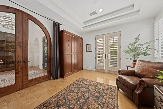 a spacious bedroom with a bed and ceiling fan