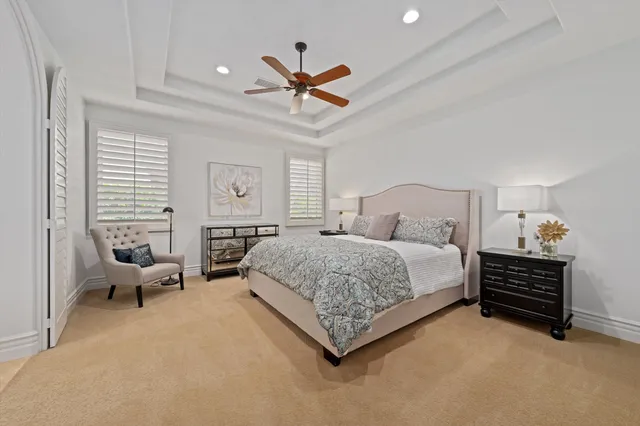 a bedroom with a bed window and a chandelier