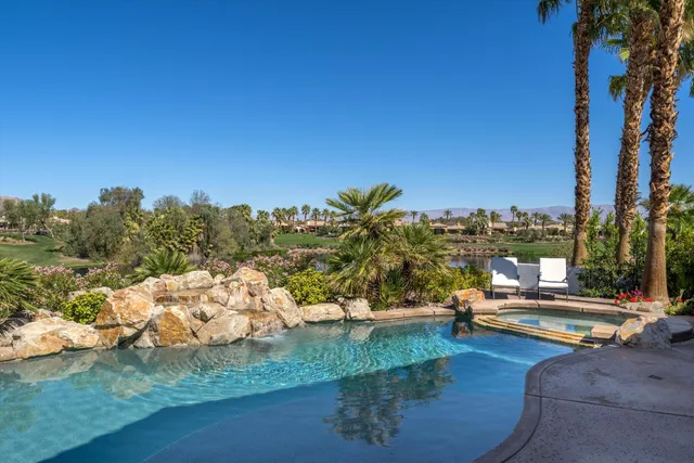a swimming pool view with a outdoor seating