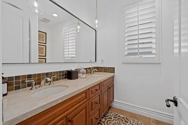 a view of a house with big yard and potted plants