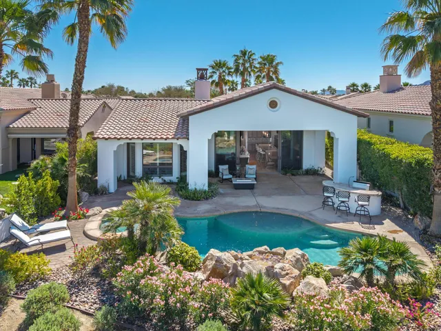 a view of a dining room with furniture and a large window
