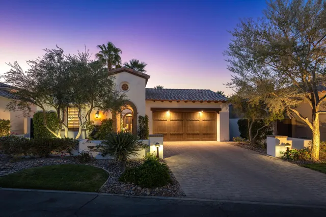 a front view of a house with a yard table and chairs