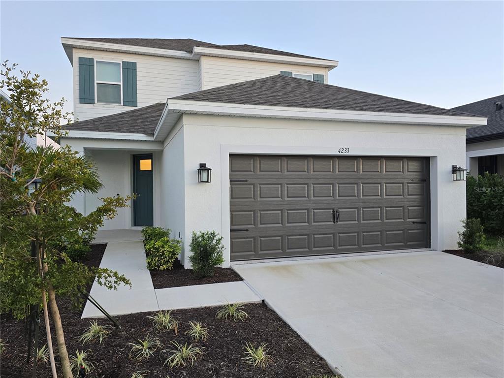4233 Pond Brk Court Lakewood Ranch, FL 34211 - Photo 1 of 49 a front view of a house with a yard